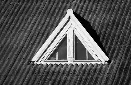 Closed wooden window on the old roof , black and white photoの写真素材