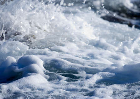 Wild water splash - wave crashing on the shore close up  の写真素材