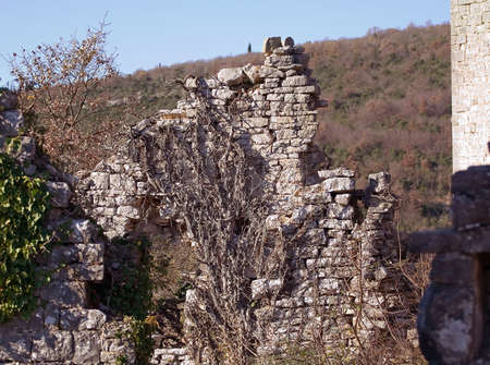 Ruins of a old abandoned stone house on a hillの写真素材