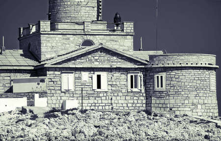 Old stone lighthouse , black and white toned photoの写真素材