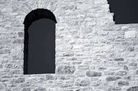 Window on a old stone wallの写真素材
