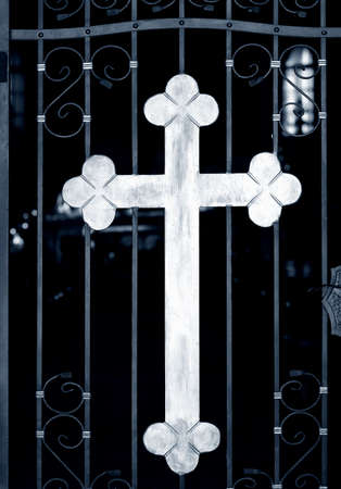 Old metal church doors with big iron crossの写真素材