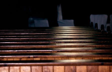 Rows of church pews with stream of lightのeditorial素材