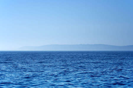 Coast as seen from the sea on a foggy dayの写真素材