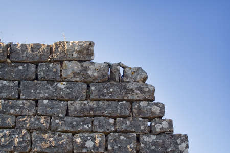 Old grunge stone wall on a ancient fortの写真素材