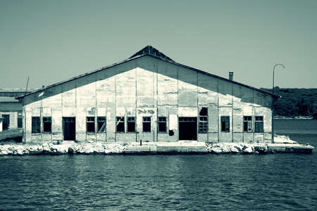 Abandoned empty warehouse in the port , toned for grungy moodの写真素材
