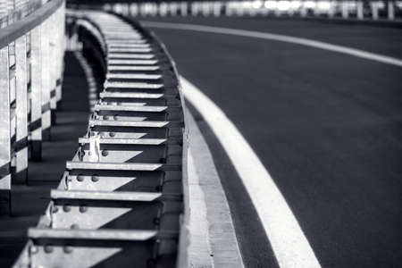 Metal fence on the the highway , black and white toned photoの写真素材