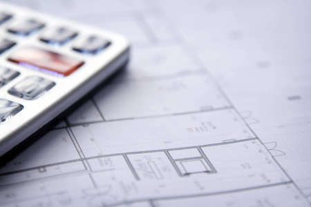 Calculator and house plan blueprints close up , shallow DOF photoの写真素材