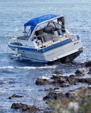 Motorboat crash on rocky shoreの写真素材