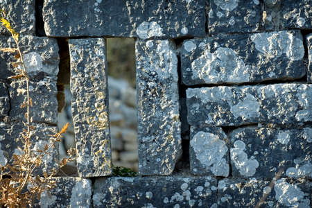 Old grunge stone wall on a ancient fortの写真素材
