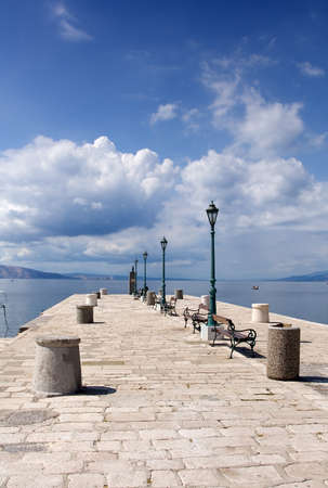 Stone pier in a small Mediterranean townの写真素材