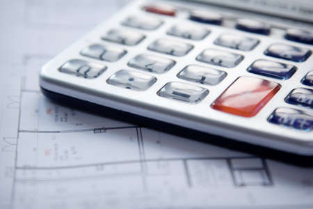 Calculator and house plan blueprints close up の写真素材