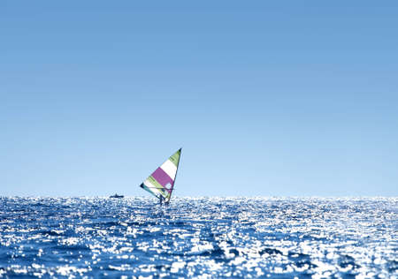 Windsurfer sailing on open seaの写真素材