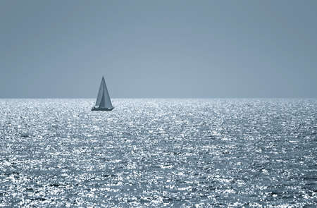 A small boat sailing on a sunny morning の写真素材