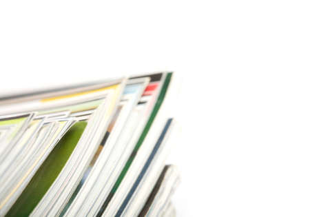 Stack of magazines studio isolated on white background with space for your textの写真素材