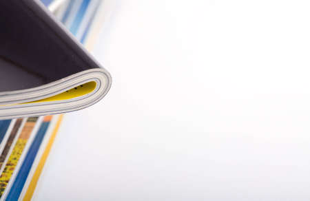 Stack of magazines studio isolated on white background with space for your textの写真素材