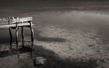 Wooden boat and pier on a lakeの写真素材