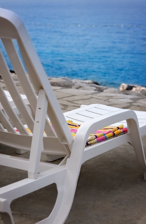 White plastic chair on the beach