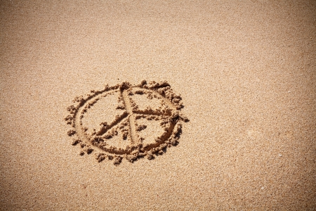 Peace symbol on the sand beach on a sunny dayの写真素材