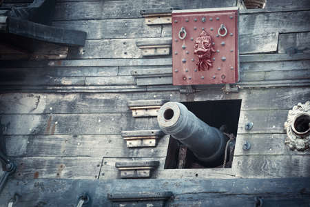 Old pirate ship on dockyard - retro style toned photo