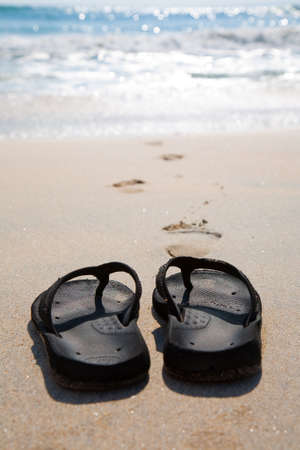 Flip flops on a sand beach on a hot sunny sumer day