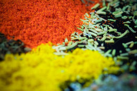 Close up of various mixed spices on dark kitchen table..の写真素材