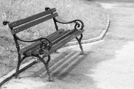 Old wooden empty bench in the park , artistic toned photoの写真素材