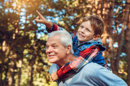 Grandfather and grandson together outdoors family conceptの写真素材