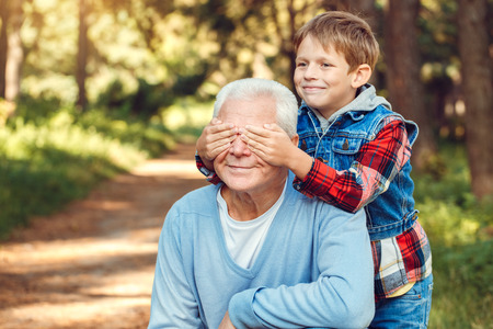 Grandfather and grandson together outdoors family conceptの写真素材