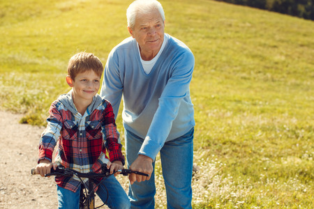 Grandfather and grandson together outdoors family conceptの写真素材