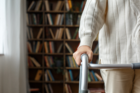 Senior woman with disability recovery at home walking frames close-upの写真素材