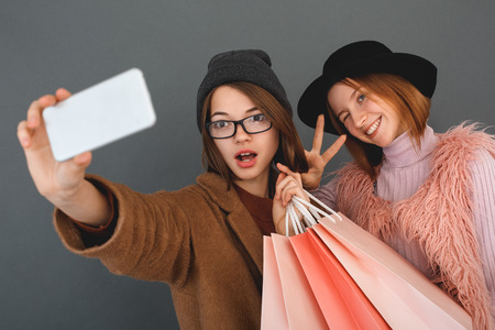 Young girls teenagers friends together shopping conceptの写真素材