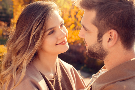Young couple walk in the autumn parkの写真素材