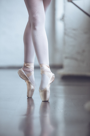 Young ballet dancer standing on toes in studio active lifestyle close-upの写真素材