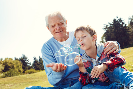 Grandfather and grandson together outdoors family conceptの写真素材