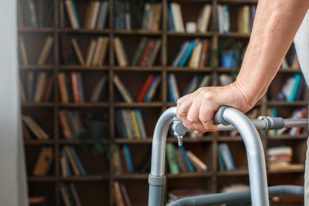 Senior woman with disability recovery at home walking frames close-upの写真素材