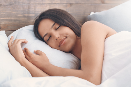 Young woman in the bed morning conceptの写真素材