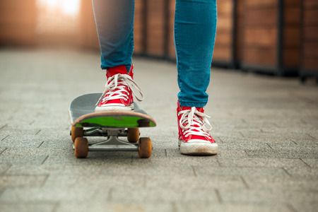 Young woman with skateboard outdoors active lifestyleの写真素材