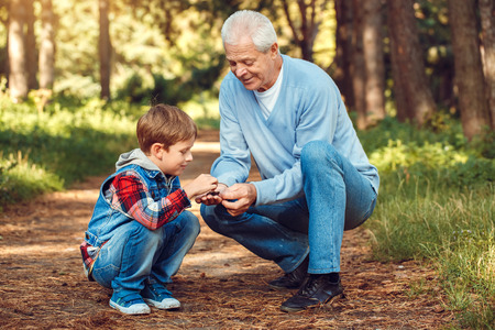 Grandfather and grandson together outdoors family conceptの写真素材