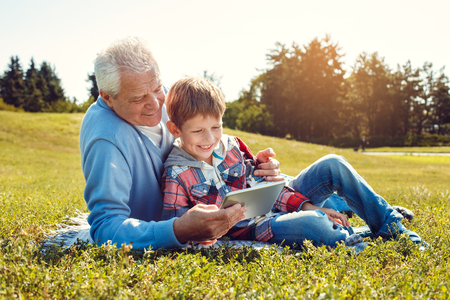Grandfather and grandson together outdoors family conceptの写真素材