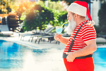 Santa Claus near the pool holiday vacation conceptの写真素材