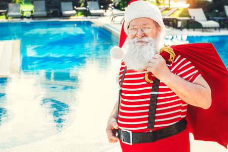 Santa Claus near the pool holiday vacation conceptの写真素材