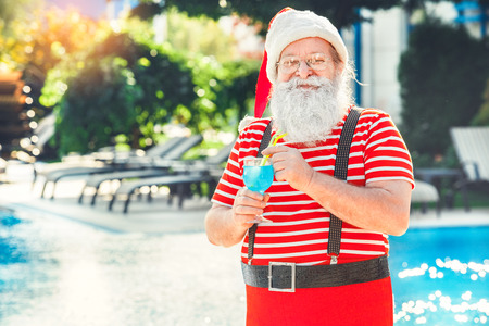 Santa Claus near the pool holiday vacation conceptの写真素材