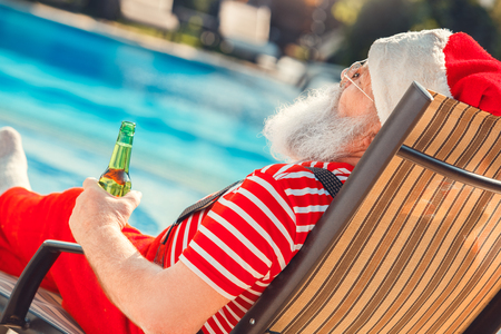 Santa Claus near the pool holiday vacation conceptの写真素材