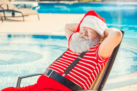 Santa Claus near the pool holiday vacation conceptの写真素材