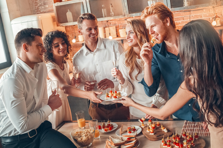 Group of friends party together indoors celebrationの写真素材