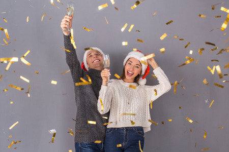Young couple studio isolated on grey wall conceptの写真素材