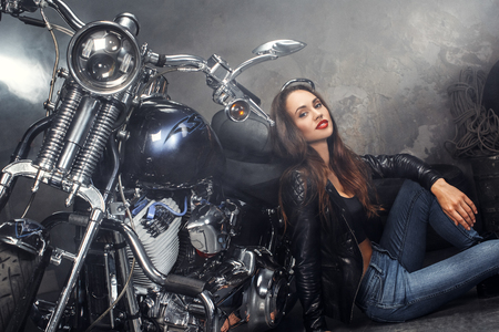 Young woman with motorcycle studioの写真素材