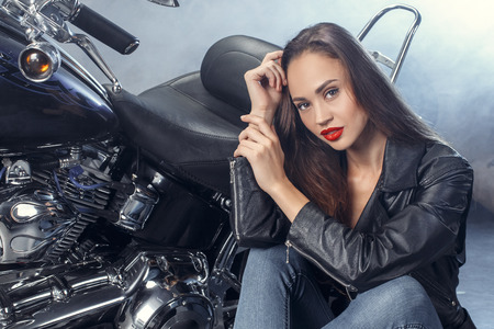 Young woman with motorcycle studio