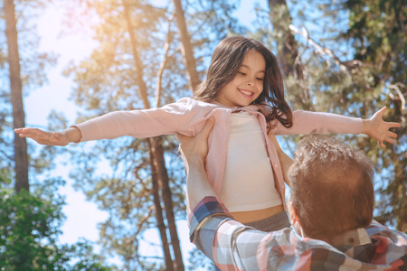 Family together outdoors in the park weekend concept playingの写真素材